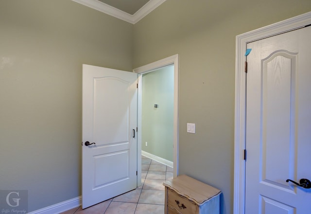 interior space with ornamental molding and light tile patterned floors