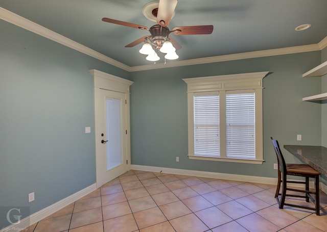 unfurnished office with ceiling fan, light tile patterned flooring, and crown molding