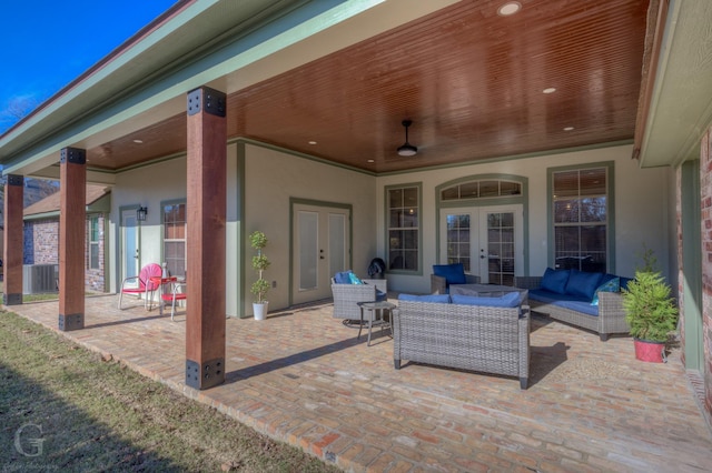 view of patio with central air condition unit, french doors, and an outdoor living space