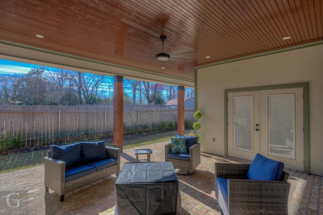 view of patio / terrace featuring ceiling fan, french doors, and an outdoor living space