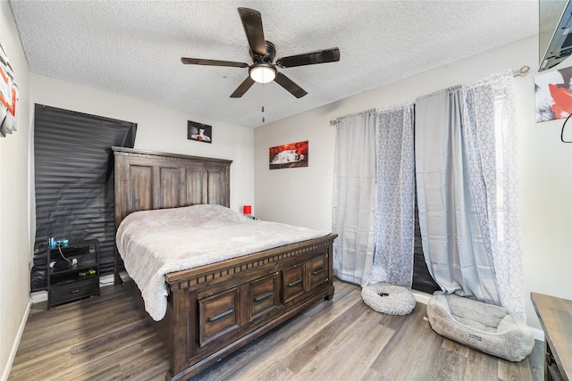 bedroom with ceiling fan, a textured ceiling, and hardwood / wood-style flooring