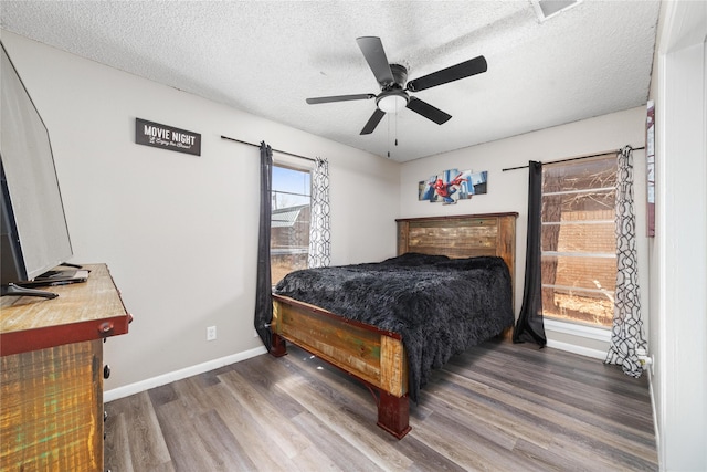 bedroom featuring ceiling fan, a textured ceiling, and hardwood / wood-style flooring