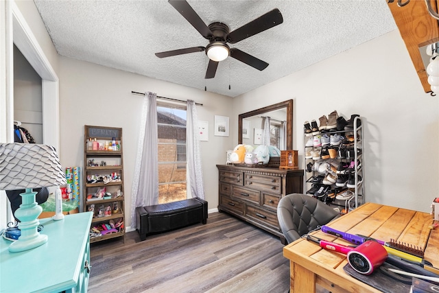 home office featuring ceiling fan, a textured ceiling, and wood-type flooring