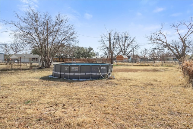 view of yard with a fenced in pool