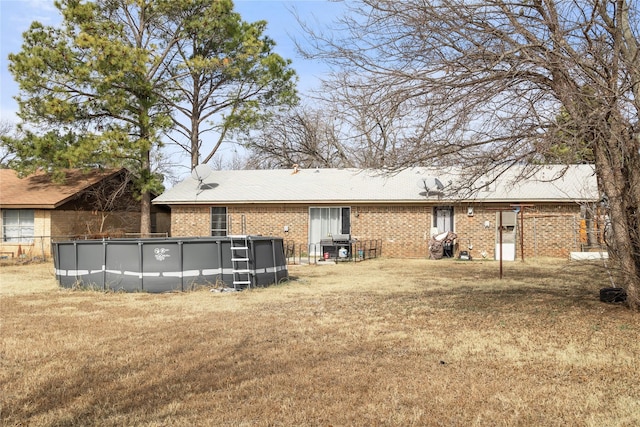 rear view of property with a lawn