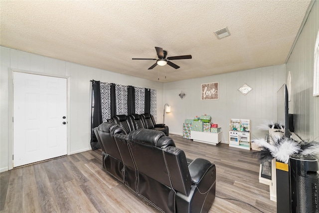 living room featuring a textured ceiling, ceiling fan, and hardwood / wood-style floors