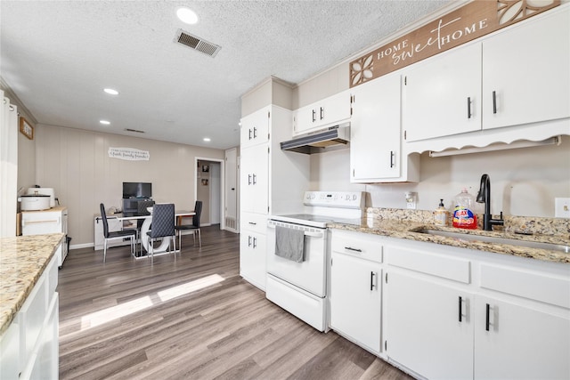 kitchen featuring white cabinets, electric stove, wood-type flooring, a textured ceiling, and sink