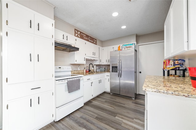 kitchen featuring a textured ceiling, white range with electric stovetop, stainless steel fridge, and white cabinetry