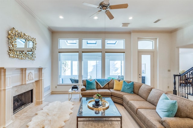 living room with a fireplace, ornamental molding, and a wealth of natural light