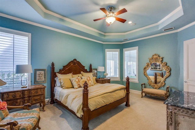 carpeted bedroom featuring a raised ceiling, ceiling fan, and crown molding