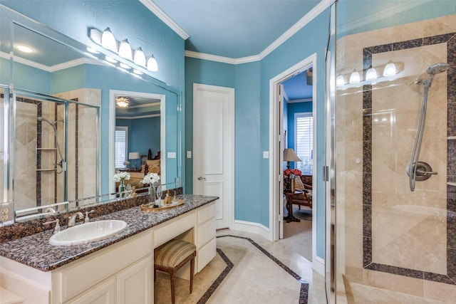 bathroom with vanity, a shower with shower door, and crown molding