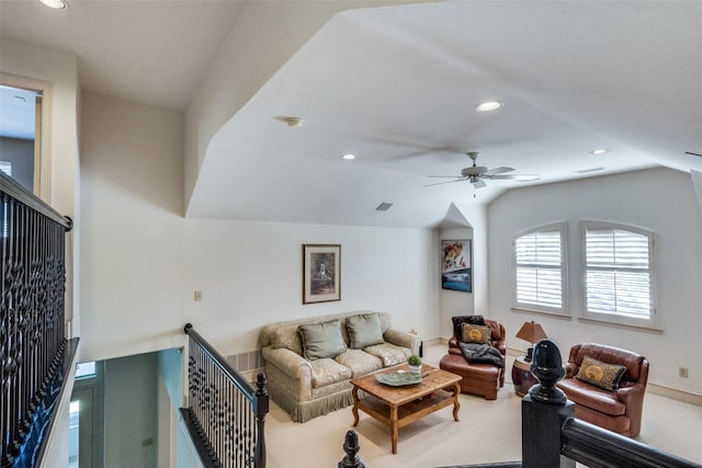 carpeted living room featuring ceiling fan and vaulted ceiling