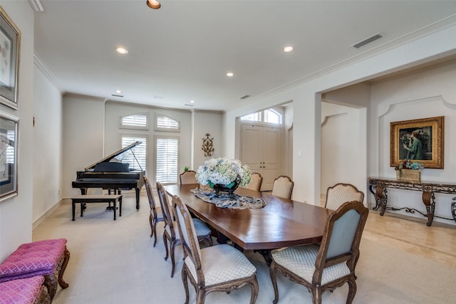 carpeted dining area with crown molding and a wealth of natural light