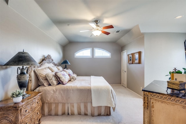 bedroom with ceiling fan, vaulted ceiling, and light carpet