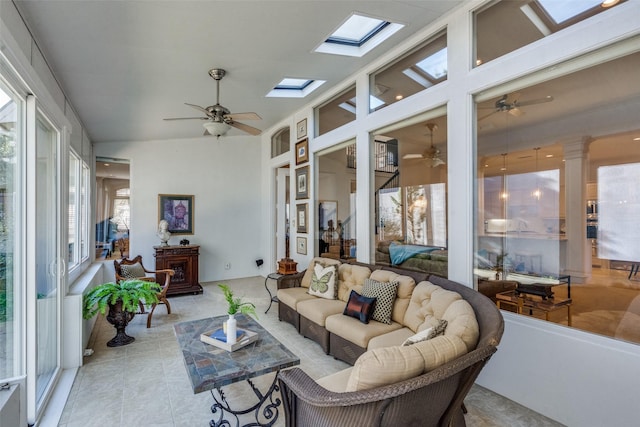 sunroom / solarium featuring decorative columns and a skylight