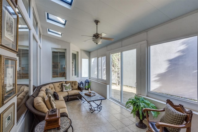 sunroom with lofted ceiling with skylight, ceiling fan, and plenty of natural light