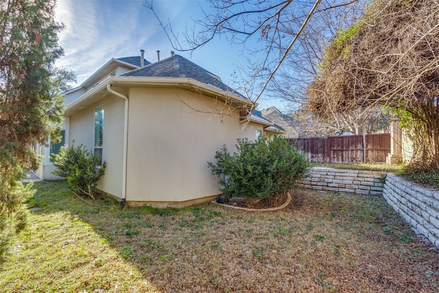 view of side of home featuring a yard