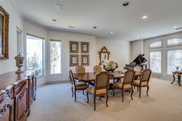 dining room featuring crown molding and light colored carpet