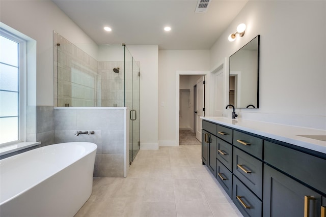 bathroom with vanity, tile patterned flooring, plenty of natural light, and shower with separate bathtub