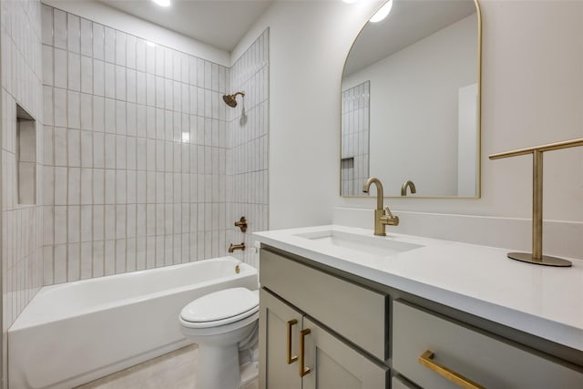 full bathroom with toilet, tiled shower / bath, and vanity