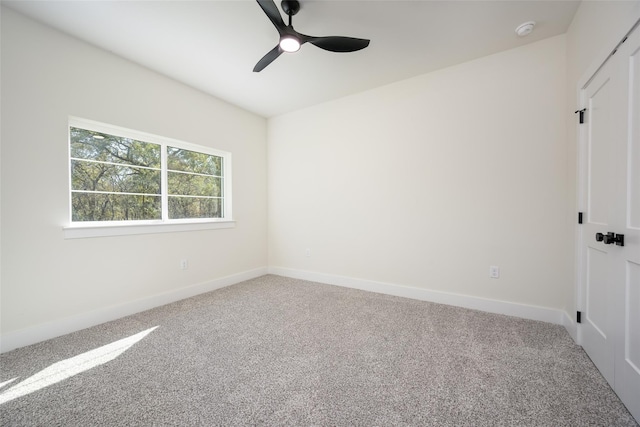 carpeted empty room with ceiling fan