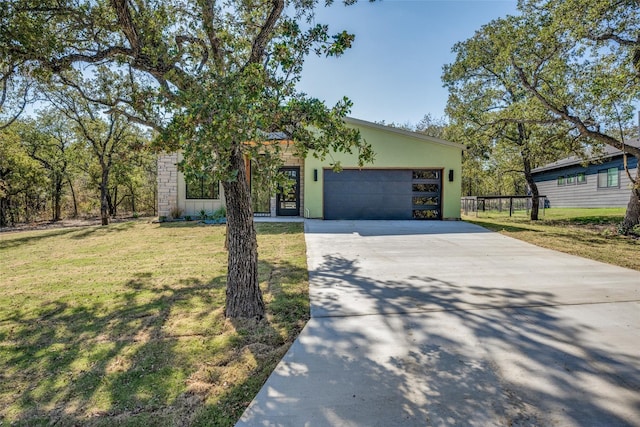 view of front of house featuring a front yard and a garage