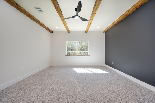 carpeted spare room featuring ceiling fan and beamed ceiling