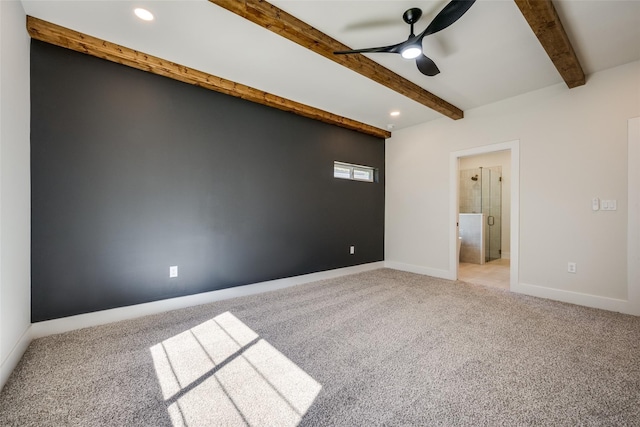 spare room featuring ceiling fan, beam ceiling, and light colored carpet