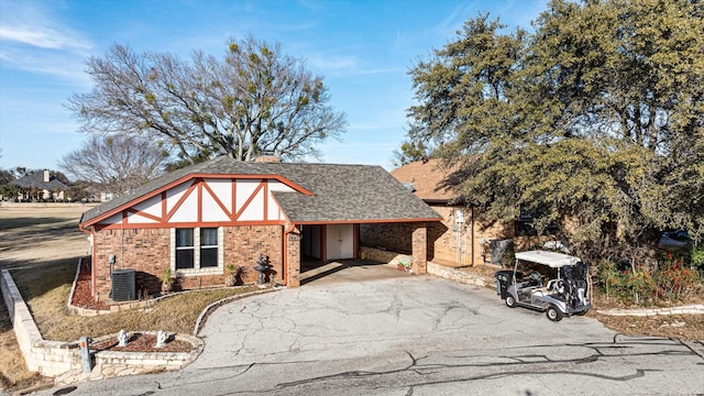 tudor-style house featuring cooling unit