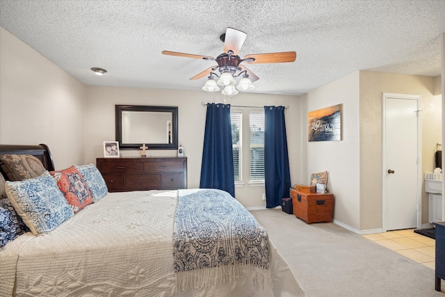 bedroom with a textured ceiling, ceiling fan, and light colored carpet