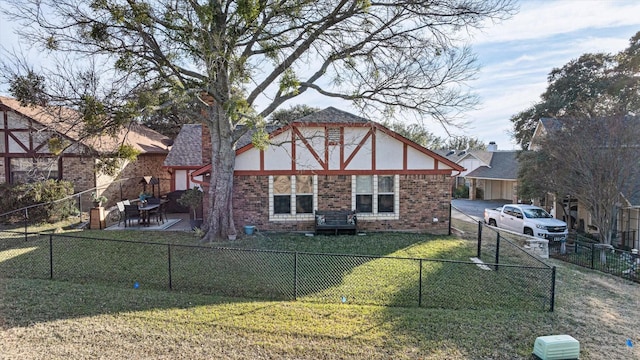 back of property with a patio area and a yard