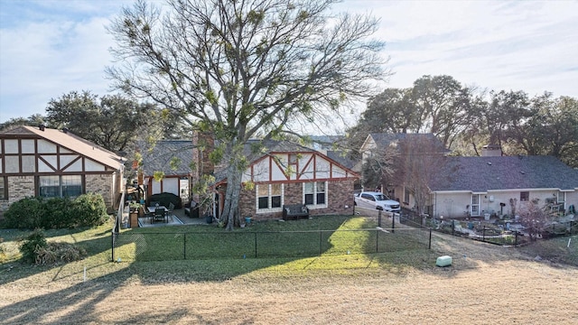 tudor home featuring a front yard