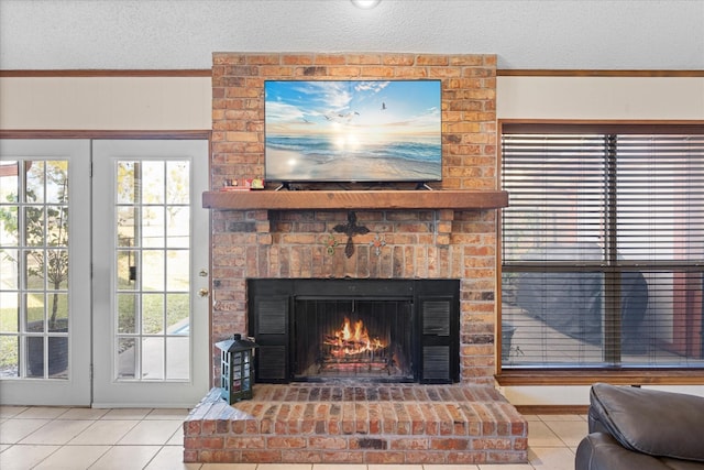 interior details featuring a brick fireplace, a textured ceiling, and crown molding