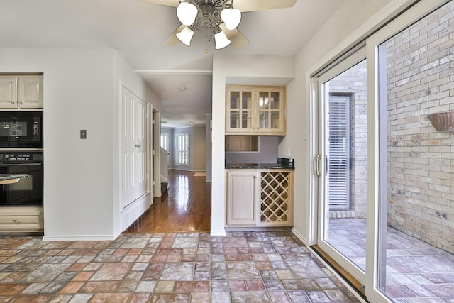 kitchen featuring ceiling fan, black appliances, and cream cabinetry