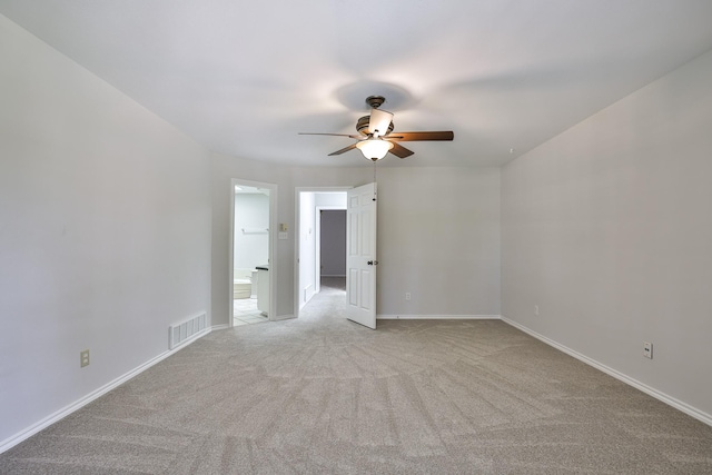 empty room with ceiling fan and light carpet