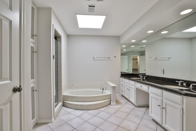 bathroom featuring independent shower and bath, vanity, and tile patterned floors