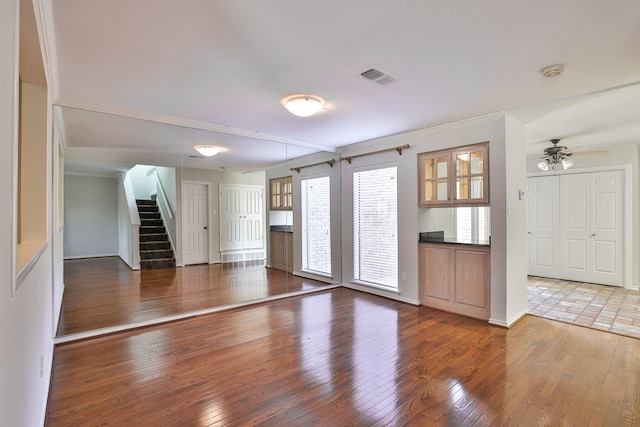 unfurnished living room with ceiling fan and hardwood / wood-style floors