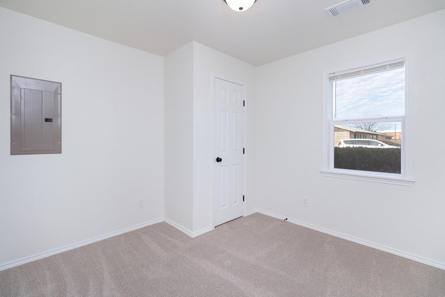 carpeted empty room with electric panel