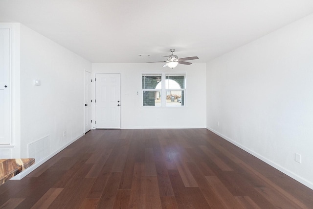 empty room featuring dark wood-type flooring and ceiling fan