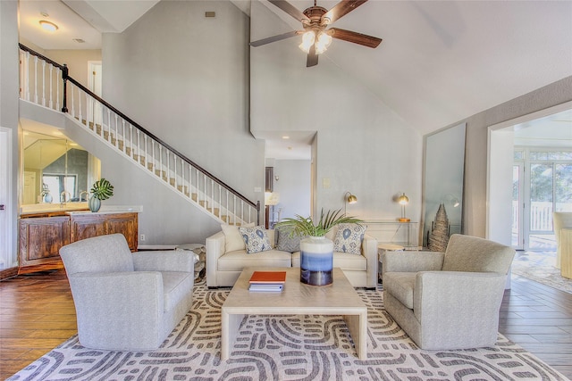 living room with high vaulted ceiling, ceiling fan, and hardwood / wood-style flooring