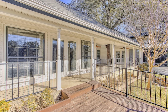 wooden terrace with a porch and ceiling fan