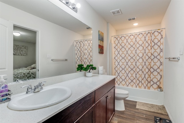 full bathroom featuring toilet, wood-type flooring, vanity, and shower / bathtub combination with curtain