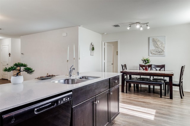 kitchen featuring dark brown cabinets, light hardwood / wood-style floors, black dishwasher, and sink