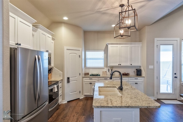 kitchen featuring sink, decorative light fixtures, white cabinetry, a kitchen island with sink, and appliances with stainless steel finishes