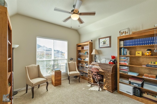 carpeted home office featuring lofted ceiling and ceiling fan