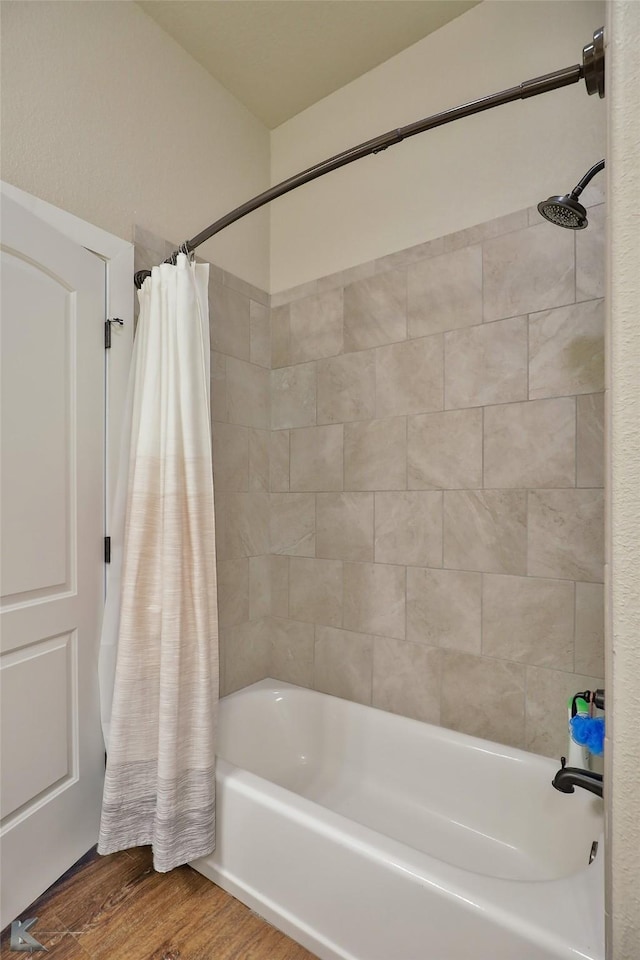 bathroom with shower / tub combo and hardwood / wood-style flooring