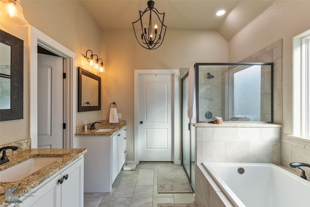 bathroom featuring an inviting chandelier, vaulted ceiling, separate shower and tub, and vanity