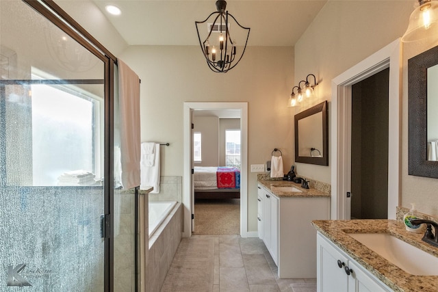 bathroom with an inviting chandelier, tile patterned floors, independent shower and bath, and vanity