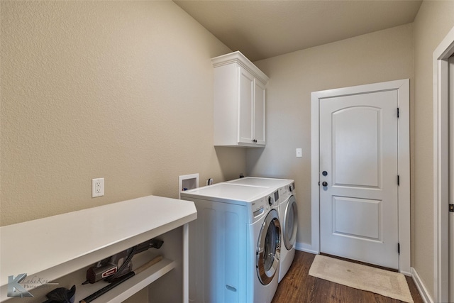 clothes washing area with separate washer and dryer, cabinets, and dark hardwood / wood-style floors