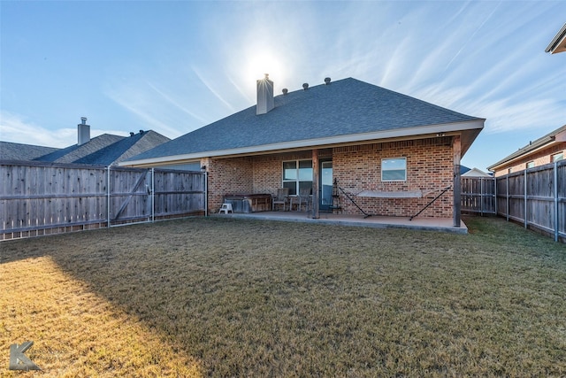 rear view of property featuring a patio and a yard